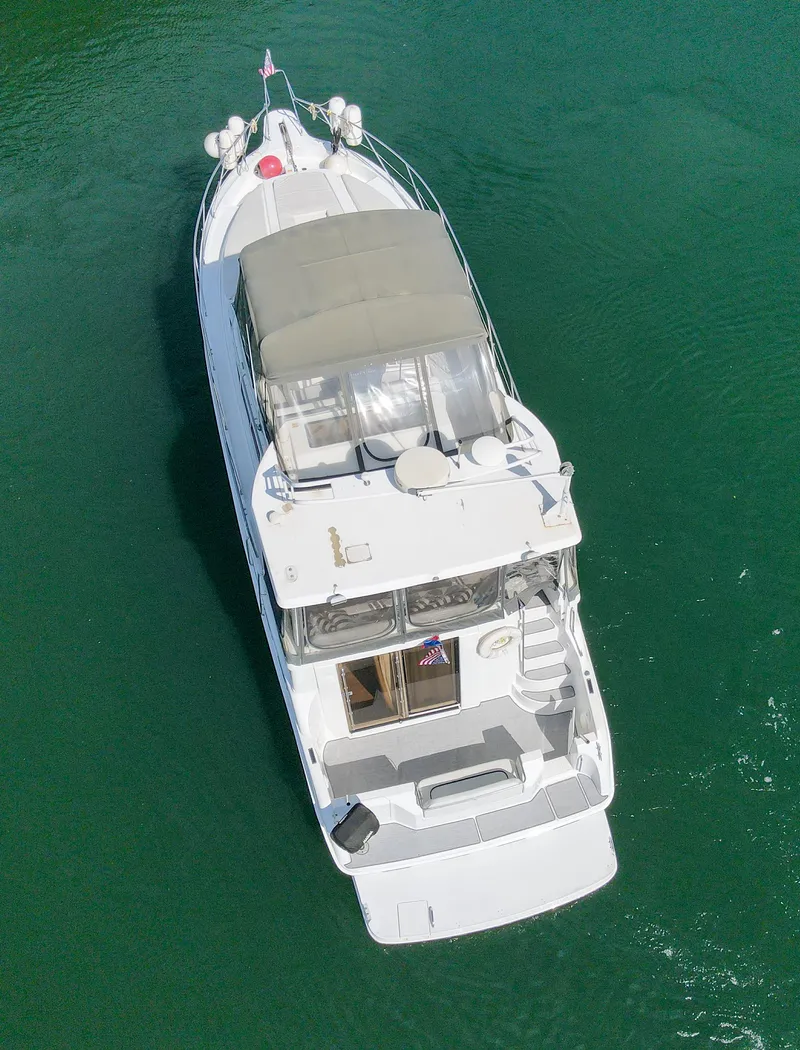 Slide: The Image of Aerial view of 1996 Silverton 442 Cockpit Motor Yacht on calm water. - 7