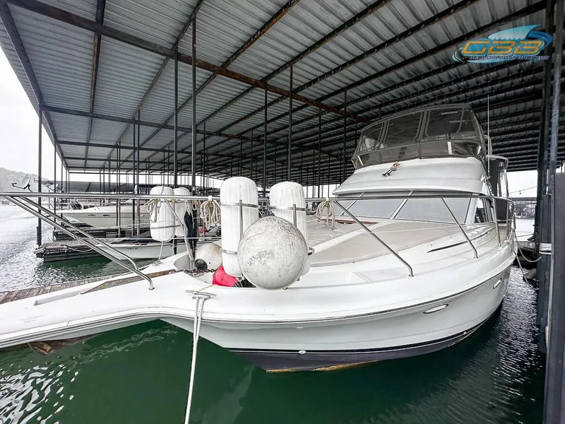 Slide: The Image of 1996 Silverton 442 Cockpit Motor Yacht docked in marina. - 8