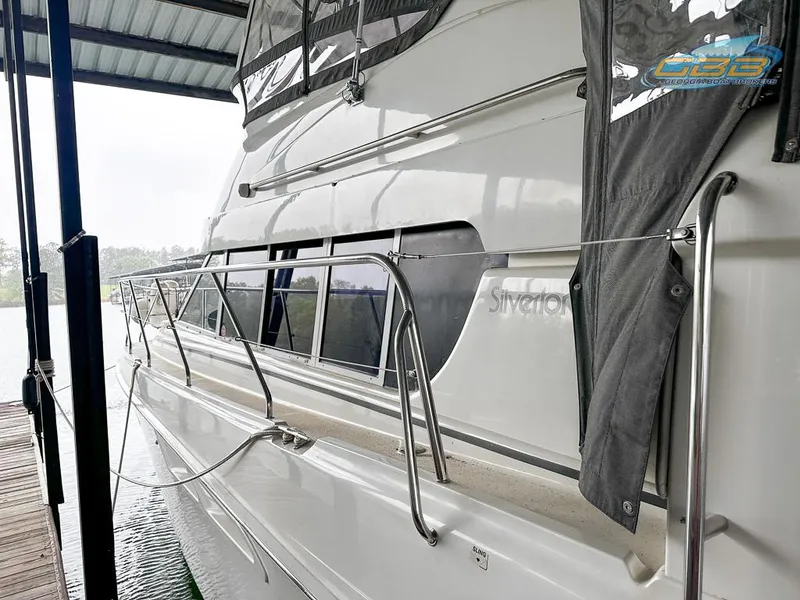 Slide: The Image of 1996 Silverton 442 Cockpit Motor Yacht docked in marina. - 9