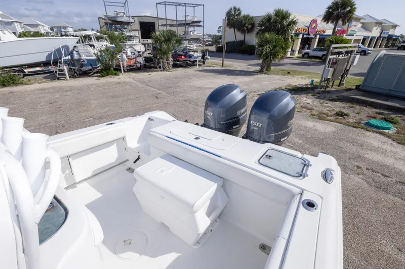Slide: The Image of 2014 Sea Hunt Gamefish 25 boat with dual Yamaha engines in a marina setting. - 12