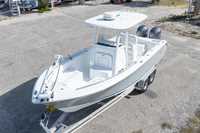 Slide: The Image of 2014 Sea Hunt Gamefish 25 boat on trailer, featuring dual engines and Garmin equipment. - 2