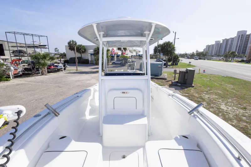 Slide: The Image of 2014 Sea Hunt Gamefish 25 boat with T-top, parked near a road and buildings. - 27