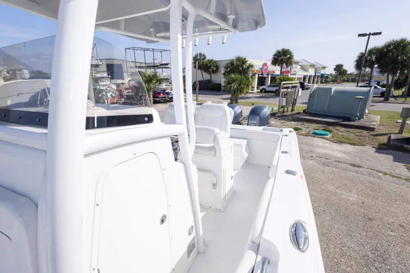 Slide: The Image of 2014 Sea Hunt Gamefish 25 boat, white interior, parked outdoors near palm trees. - 31