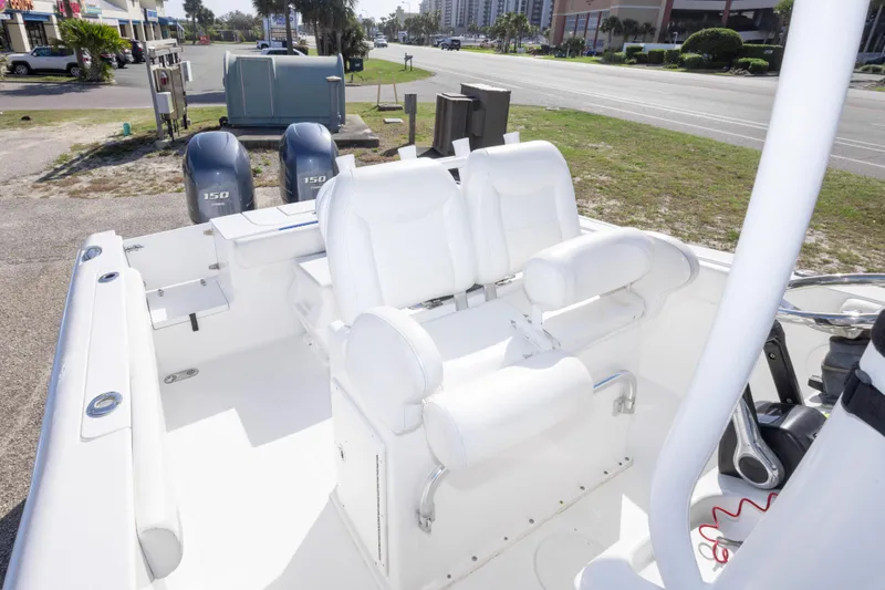 Slide: The Image of 2014 Sea Hunt Gamefish 25 boat interior with dual engines and white seating. - 33