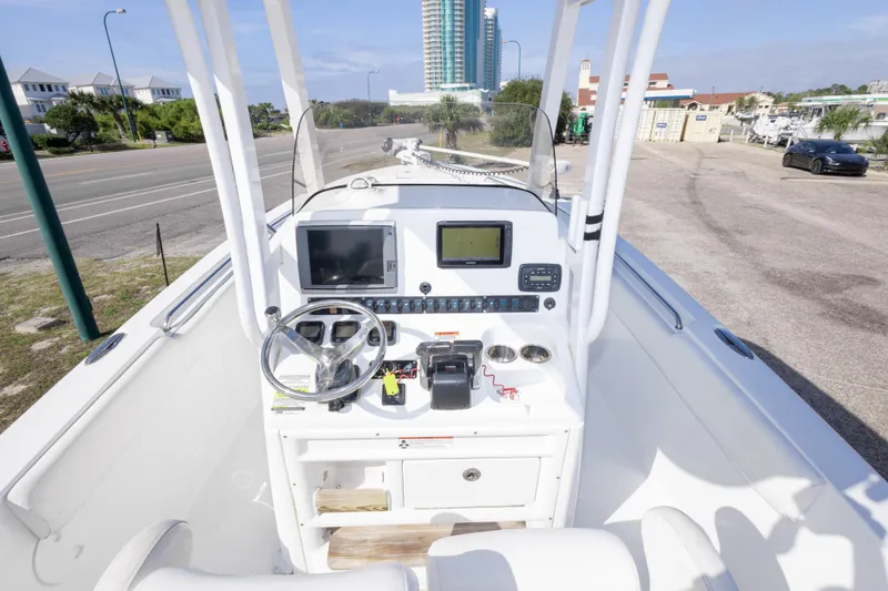 Slide: The Image of 2014 Sea Hunt Gamefish 25 boat console with steering wheel and navigation equipment. - 34