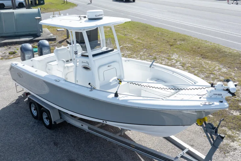 Slide: The Image of 2014 Sea Hunt Gamefish 25 boat on trailer, featuring dual engines and Garmin equipment. - 35