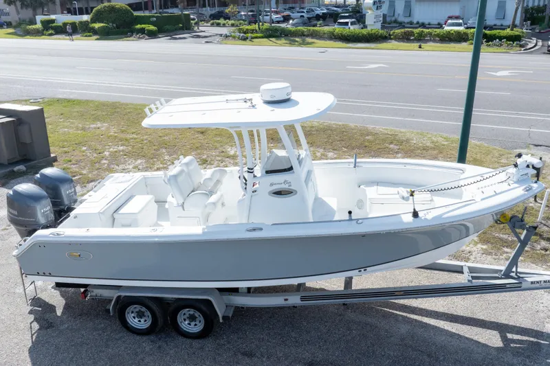 Slide: The Image of 2014 Sea Hunt Gamefish 25 boat on trailer, parked near a road. - 36