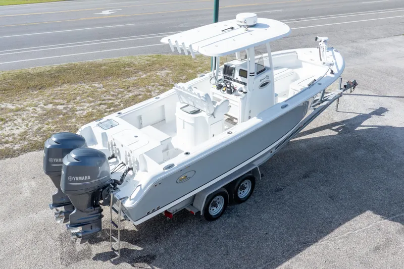Slide: The Image of 2014 Sea Hunt Gamefish 25 boat with dual Yamaha engines on a trailer. - 37
