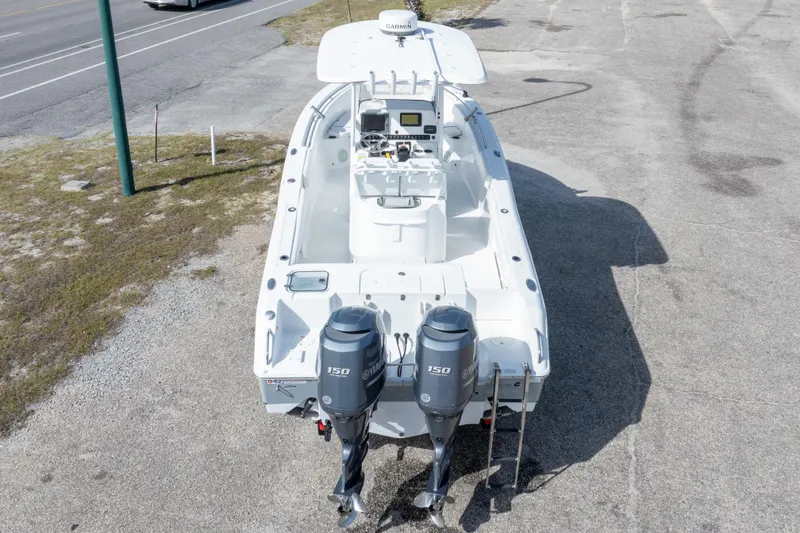 Slide: The Image of 2014 Sea Hunt Gamefish 25 boat with dual Yamaha 150 engines, parked on pavement. - 38