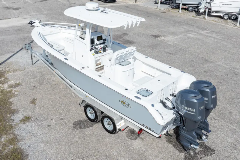 Slide: The Image of 2014 Sea Hunt Gamefish 25 boat with dual Yamaha engines on a trailer. - 39