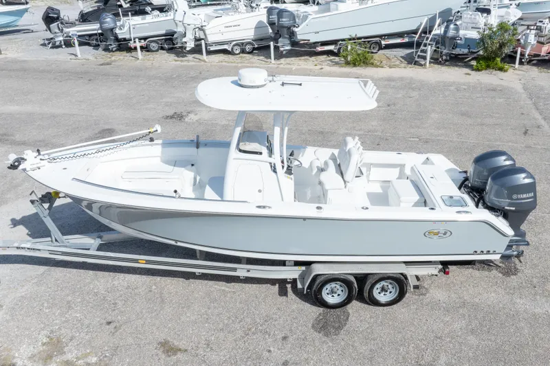 Slide: The Image of 2014 Sea Hunt Gamefish 25 boat on trailer, featuring dual Yamaha engines. - 40