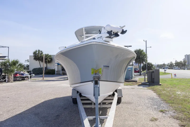 Slide: The Image of 2014 Sea Hunt Gamefish 25 boat on trailer, parked outdoors on a sunny day. - 45