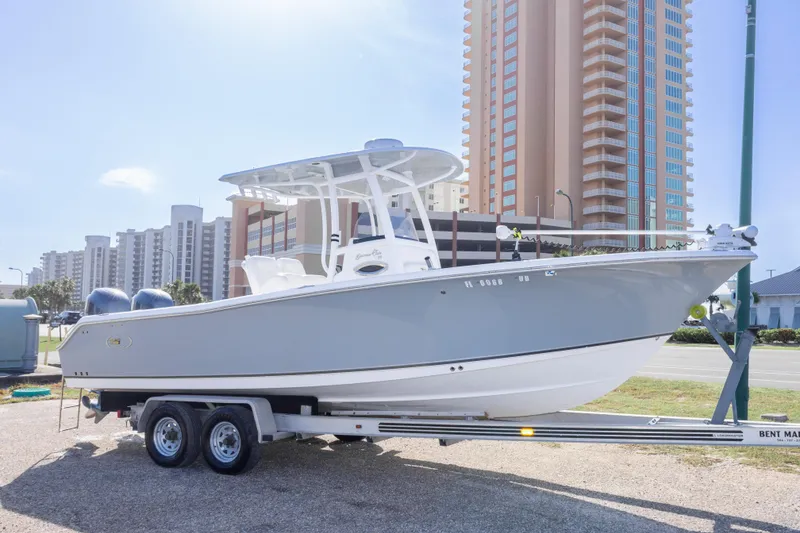 Slide: The Image of 2014 Sea Hunt Gamefish 25 boat on trailer, urban background, sunny day. - 5