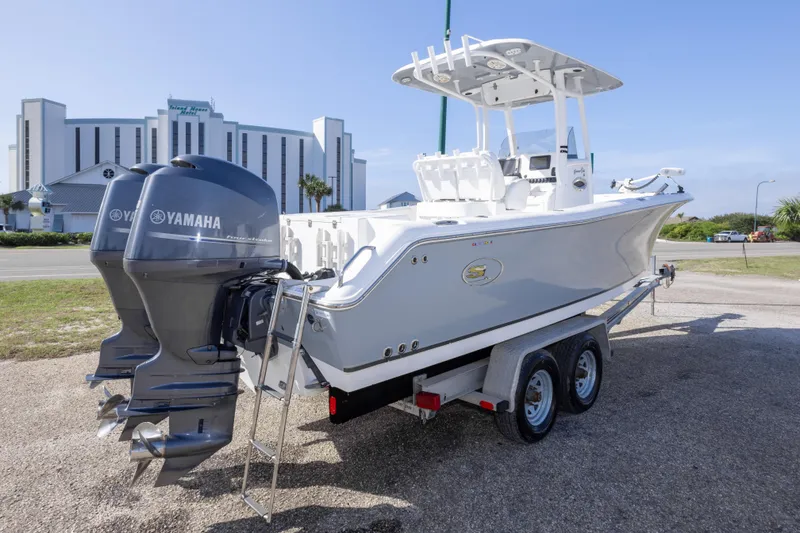 Slide: The Image of 2014 Sea Hunt Gamefish 25 boat with Yamaha engines on a trailer. - 7