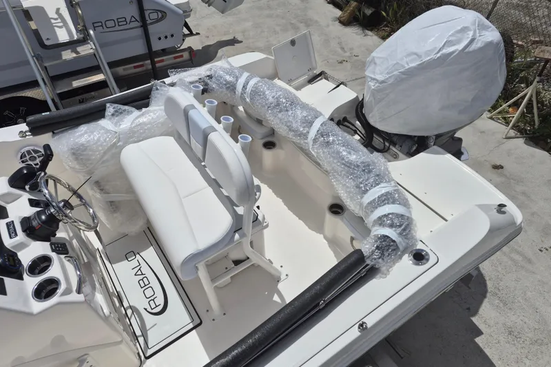 Slide: The Image of 2026 Robalo R180 Center Console boat interior with wrapped components and steering console. - 4