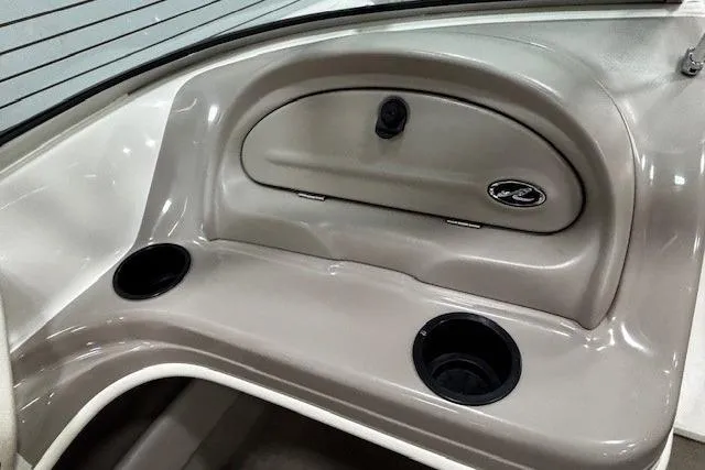 Slide: The Image of Interior of a 2002 Sea Ray 182 Bow Rider boat with cup holders and storage compartment. - 11