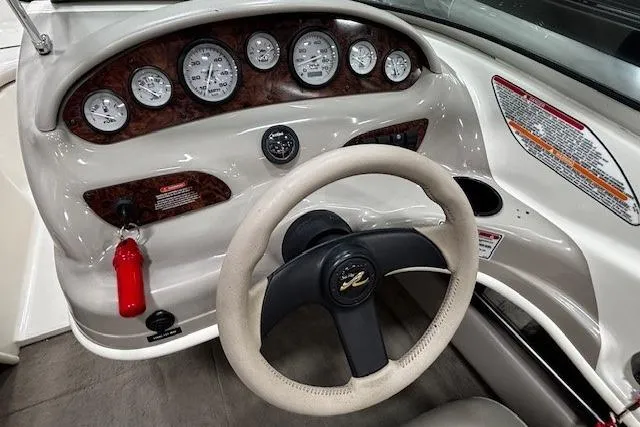 Slide: The Image of 2002 Sea Ray 182 Bow Rider dashboard with gauges and steering wheel. - 14
