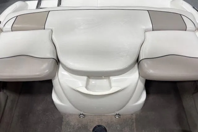 Slide: The Image of 2002 Sea Ray 182 Bow Rider interior seating, featuring white and beige upholstery. - 16