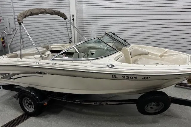 Slide: The Image of 2002 Sea Ray 182 Bow Rider boat on trailer in indoor storage. - 2
