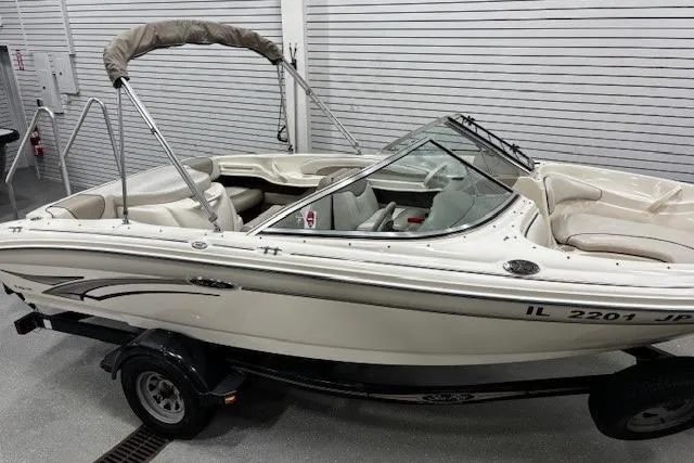 Slide: The Image of 2002 Sea Ray 182 Bow Rider boat on trailer in indoor storage. - 21