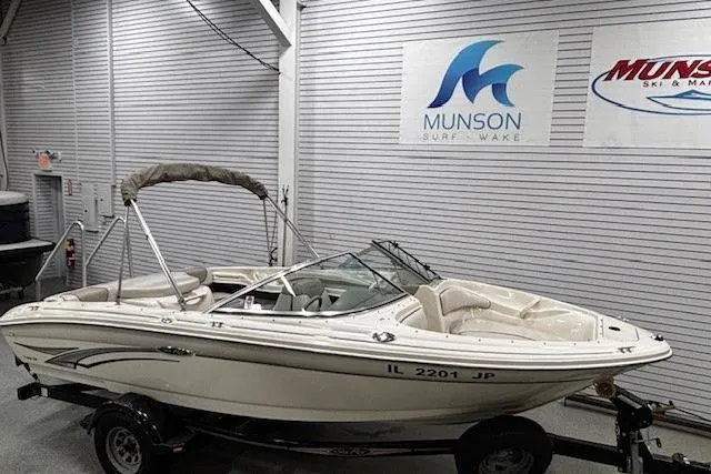 Slide: The Image of 2002 Sea Ray 182 Bow Rider boat on trailer in showroom with Munson signage. - 22