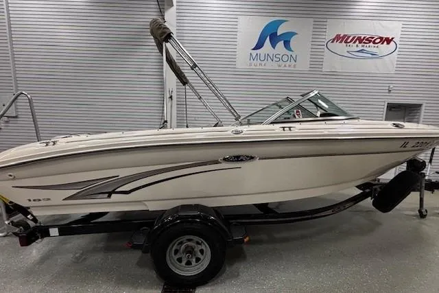 Slide: The Image of 2002 Sea Ray 182 Bow Rider boat on trailer in showroom. - 26