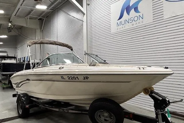 Slide: The Image of 2002 Sea Ray 182 Bow Rider boat on trailer in showroom. - 28