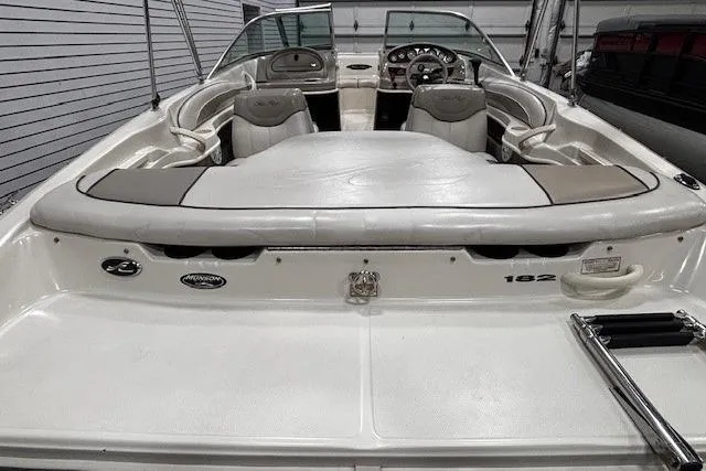 Slide: The Image of 2002 Sea Ray 182 Bow Rider boat interior with seating and dashboard view. - 30