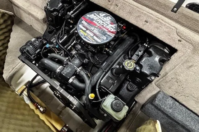 Slide: The Image of Engine compartment of a 2002 Sea Ray 182 Bow Rider boat, featuring a 4.3L MerCruiser engine. - 31