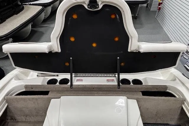 Slide: The Image of 2002 Sea Ray 182 Bow Rider interior with open storage compartment and seating area. - 34