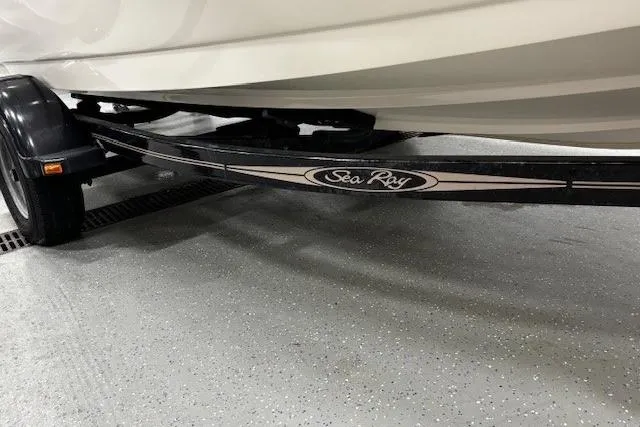 Slide: The Image of Trailer of a 2002 Sea Ray 182 Bow Rider boat in a garage setting. - 37