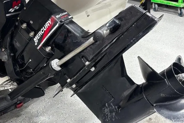 Slide: The Image of Outboard motor of a 2002 Sea Ray 182 Bow Rider with Mercury branding. - 38