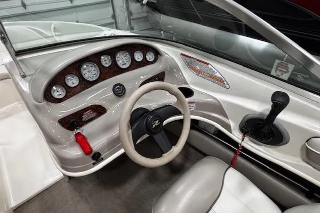 Slide: The Image of 2002 Sea Ray 182 Bow Rider dashboard with steering wheel and instrument panel. - 4
