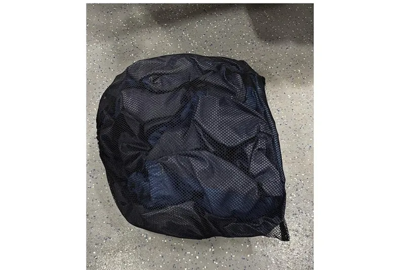 Slide: The Image of Black mesh bag on speckled floor, possibly containing boat accessories. - 40
