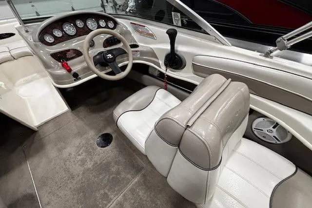 Slide: The Image of Interior of a 2002 Sea Ray 182 Bow Rider boat with steering wheel and seating. - 5