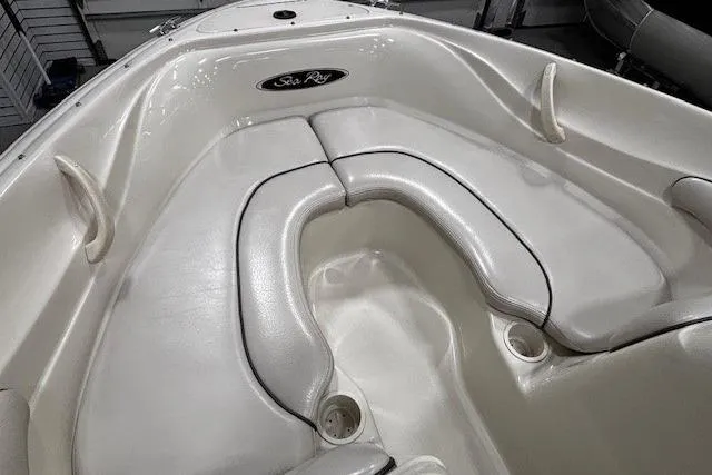 Slide: The Image of 2002 Sea Ray 182 Bow Rider interior with white cushioned seating. - 6