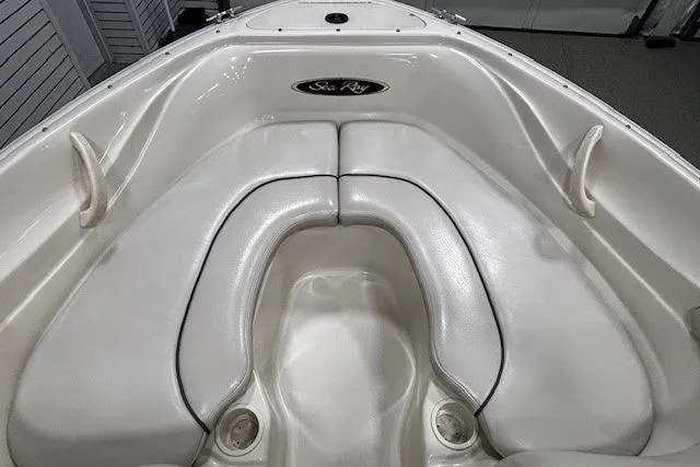 Slide: The Image of 2002 Sea Ray 182 Bow Rider boat interior with white cushioned seating. - 7