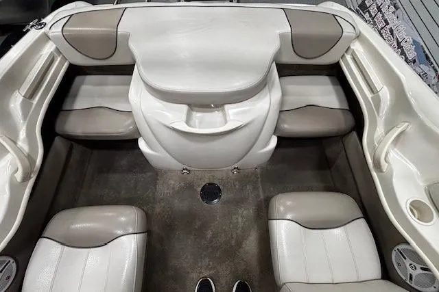 Slide: The Image of Interior view of a 2002 Sea Ray 182 Bow Rider boat, featuring beige and white seating. - 9