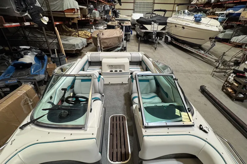 Slide: The Image of 1991 Sea Ray 185 Bow Rider boat in storage, interior view with seating and steering wheel. - 12