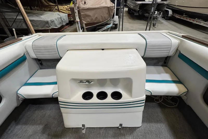 Slide: The Image of Interior of a 1991 Sea Ray 185 Bow Rider boat with white and teal seating. - 2