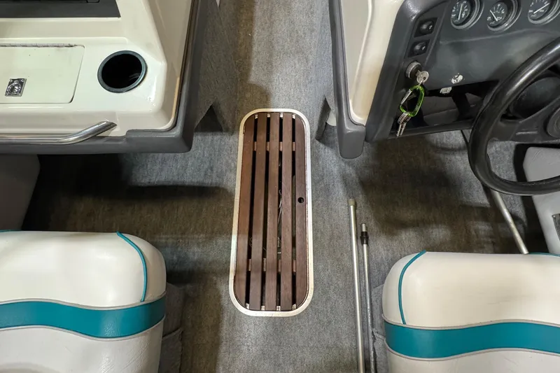 Slide: The Image of Interior of a 1991 Sea Ray 185 Bow Rider boat, showing steering wheel and seating. - 7