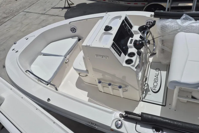 Slide: The Image of 2026 Robalo R180 Center Console boat interior with steering wheel and seating. - 12
