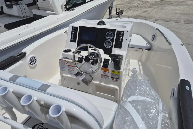 Slide: The Image of 2026 Robalo R180 Center Console boat interior with steering wheel and control panel. - 14