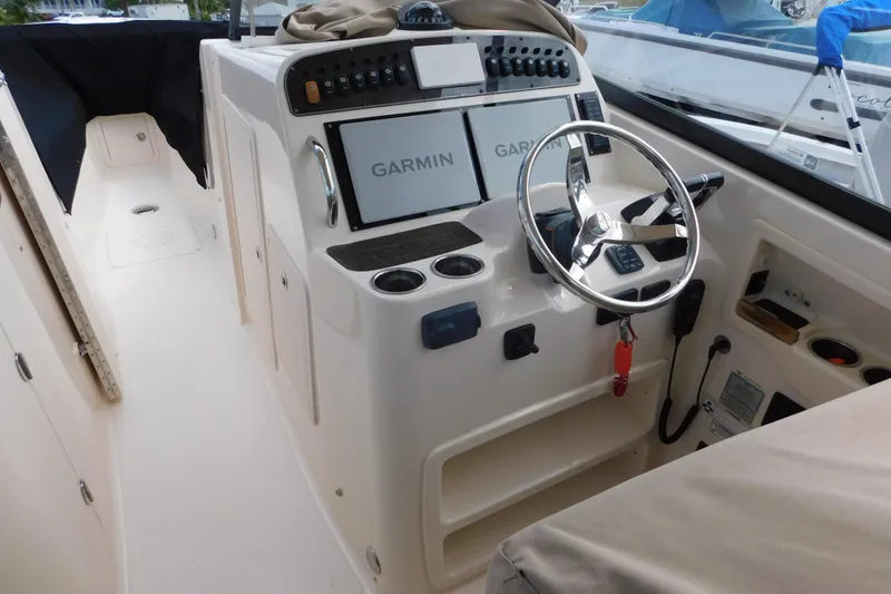 Slide: The Image of 2015 Grady-White Freedom 307 boat cockpit with Garmin navigation system and steering wheel. - 15