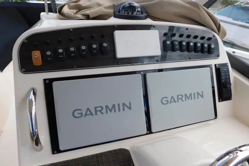 Slide: The Image of Control panel of 2015 Grady-White Freedom 307 boat with Garmin displays. - 16