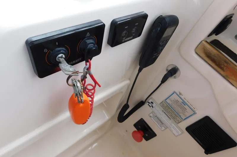Slide: The Image of Control panel of a 2015 Grady-White Freedom 307 boat with keys and radio. - 19