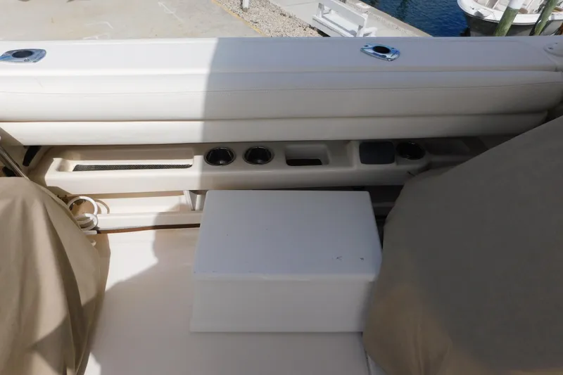 Slide: The Image of 2015 Grady-White Freedom 307 boat interior with seating and storage compartments. - 27