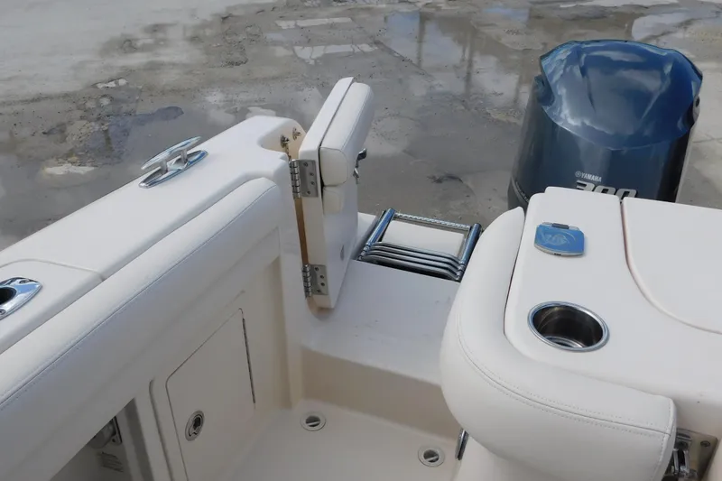Slide: The Image of 2015 Grady-White Freedom 307 boat interior with Yamaha engine and seating area. - 29