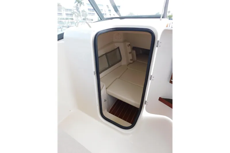 Slide: The Image of 2015 Grady-White Freedom 307 cabin interior with seating and window view. - 30