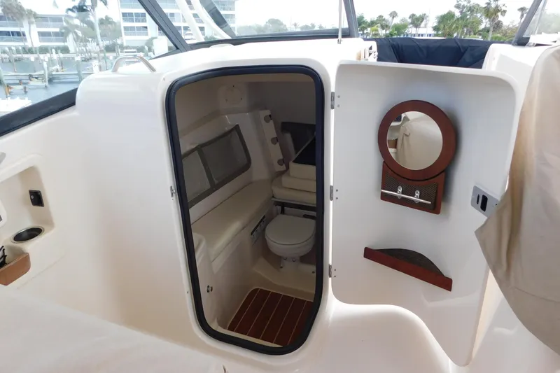 Slide: The Image of 2015 Grady-White Freedom 307 boat interior with compact bathroom and mirror. - 31